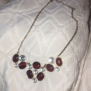 gold necklace with red and clear stones